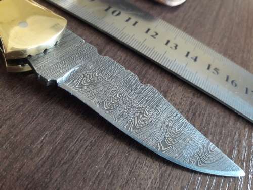Handmade Damascus steel folding knife with Wooden handle scales.