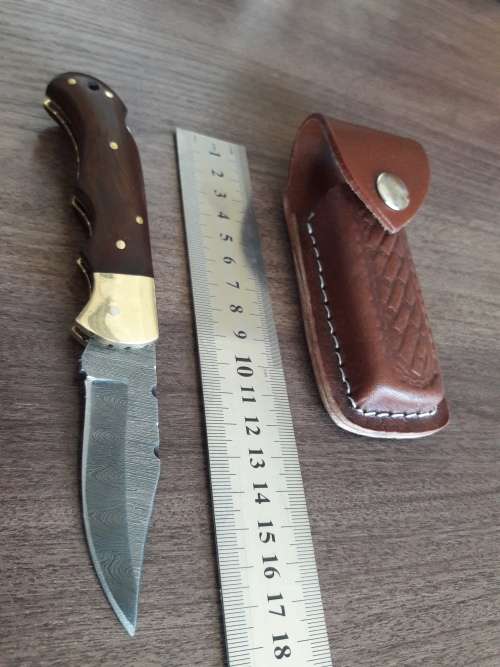 Handmade Damascus steel folding knife with Wooden handle scales.
