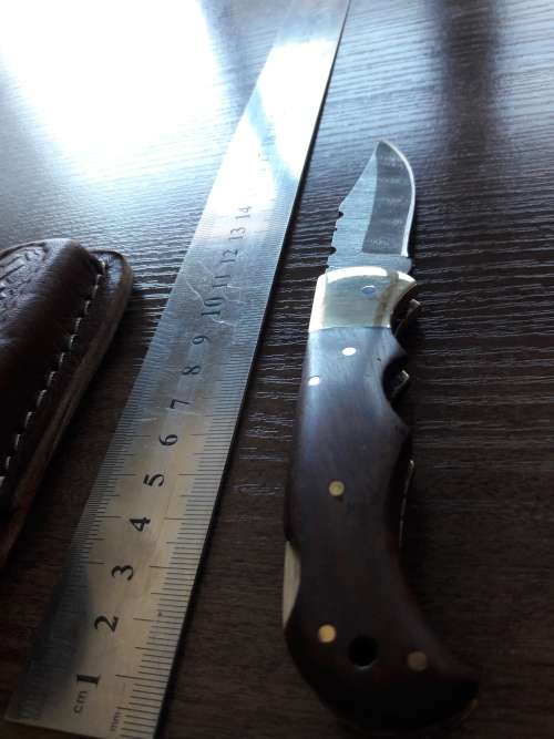 Handmade Damascus steel folding knife with Wooden handle scales.