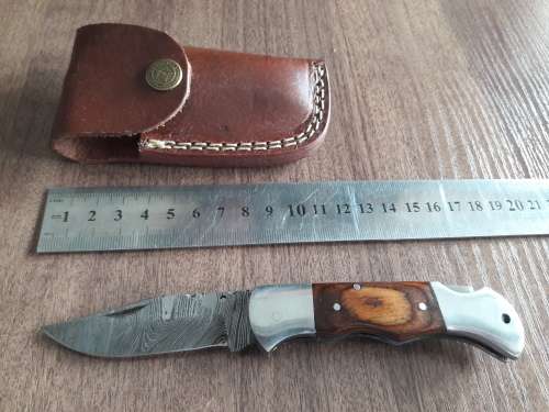 Handmade Damascus steel folding knife with Wooden handle scales.