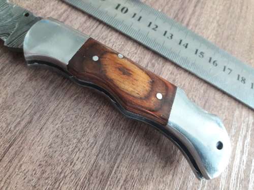 Handmade Damascus steel folding knife with Wooden handle scales.