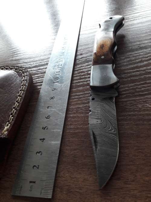 Handmade Damascus steel folding knife with Wooden handle scales.