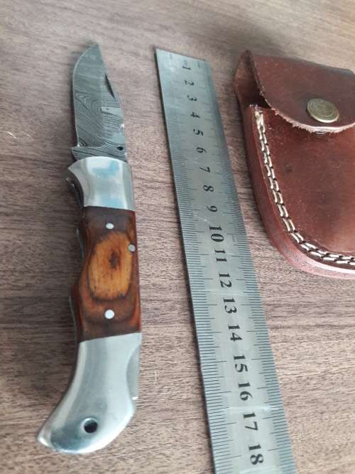 Handmade Damascus steel folding knife with Wooden handle scales.