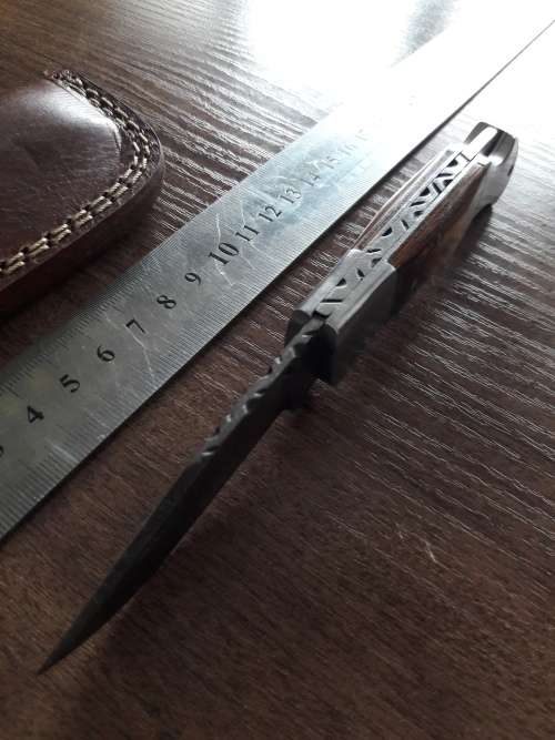 Handmade Damascus steel folding knife with Wooden handle scales.