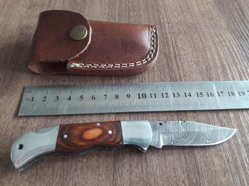 Handmade Damascus steel folding knife with Wooden handle scales.