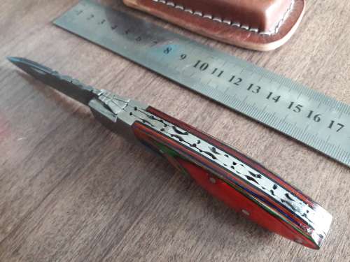 Handmade Damascus steel folding knife with Wooden handle scales.