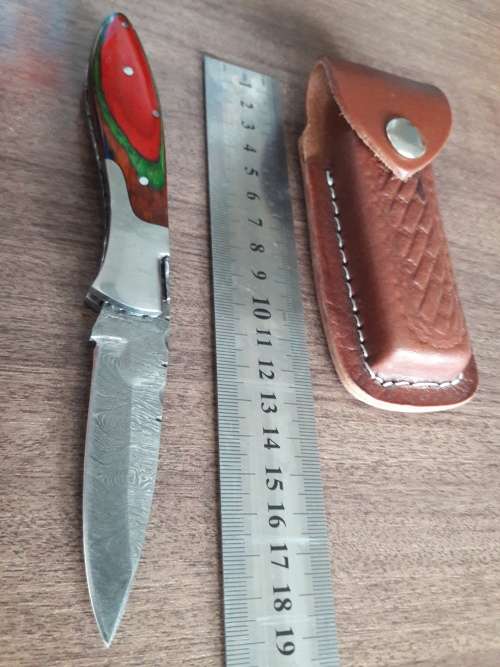 Handmade Damascus steel folding knife with Wooden handle scales.