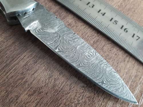 Handmade Damascus steel folding knife with Wooden handle scales.