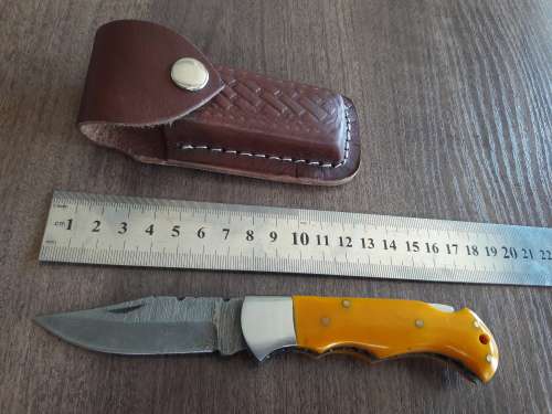 Handmade Damascus steel folding knife with Resin handle scales.