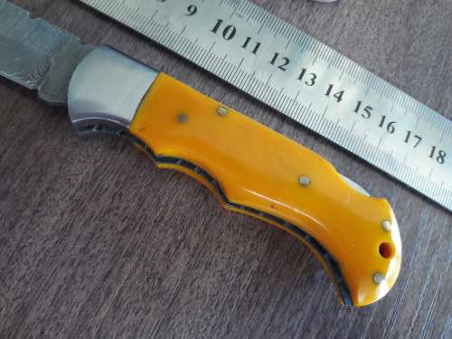 Handmade Damascus steel folding knife with Resin handle scales.