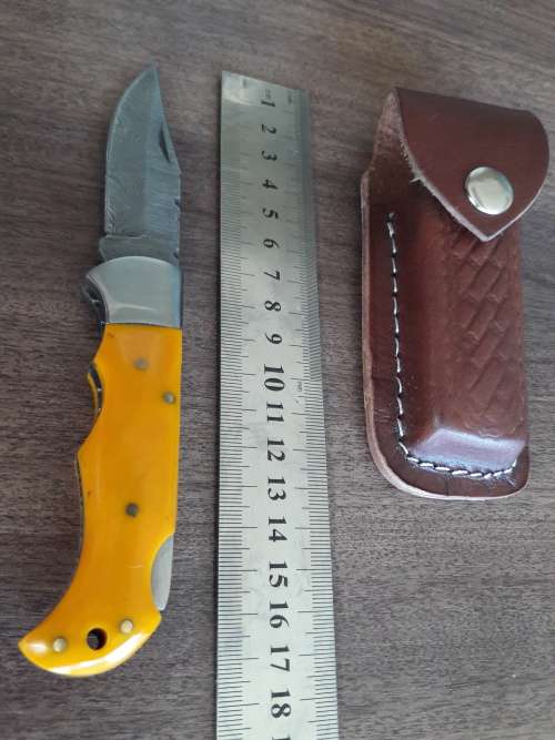 Handmade Damascus steel folding knife with Resin handle scales.