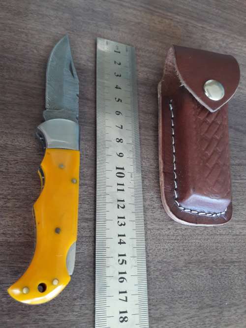 Handmade Damascus steel folding knife with Resin handle scales.