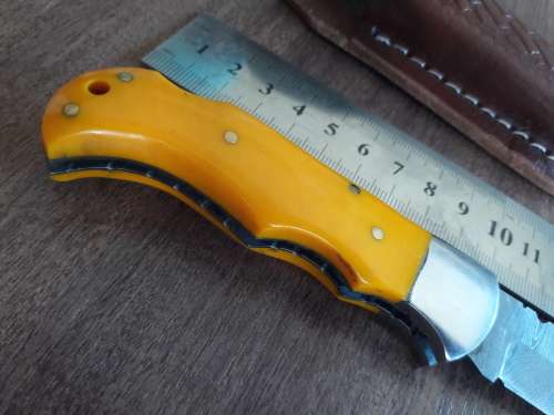 Handmade Damascus steel folding knife with Resin handle scales.