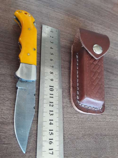 Handmade Damascus steel folding knife with Resin handle scales.