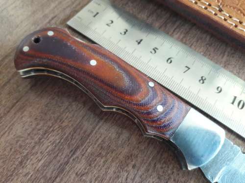 Handmade Damascus steel folding knife with MICARTA handle scales. THIS AUCTION will only ship 28th