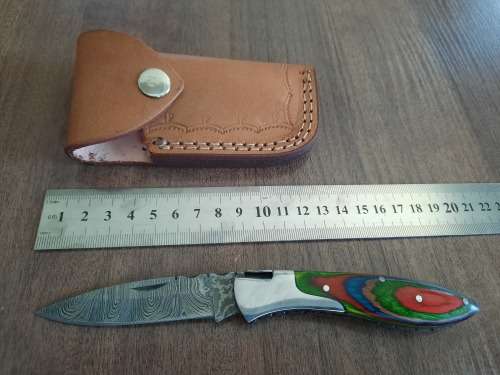 Handmade Damascus steel folding knife with Wooden handle scales.