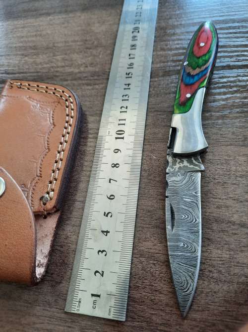 Handmade Damascus steel folding knife with Wooden handle scales.