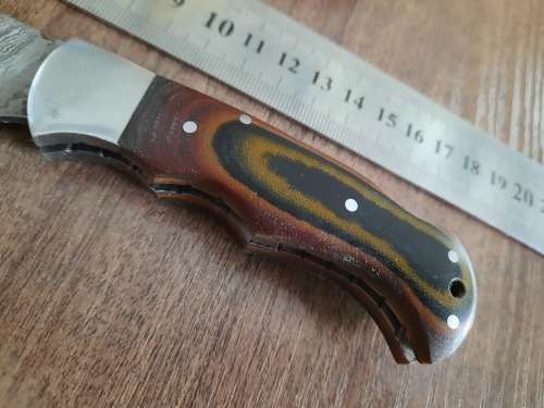 Handmade Damascus steel folding knife with MICARTA handle scales.