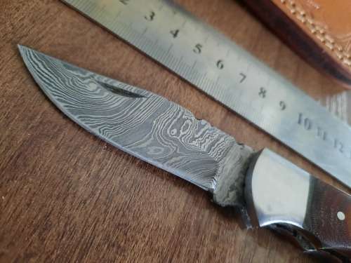 Handmade Damascus steel folding knife with MICARTA handle scales.