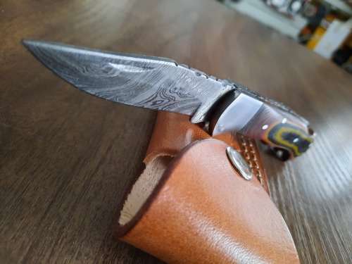Handmade Damascus steel folding knife with MICARTA handle scales.
