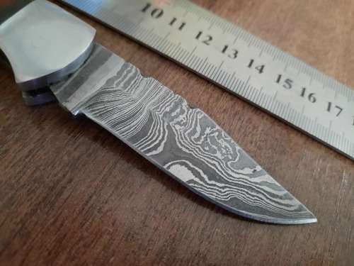 Handmade Damascus steel folding knife with MICARTA handle scales.