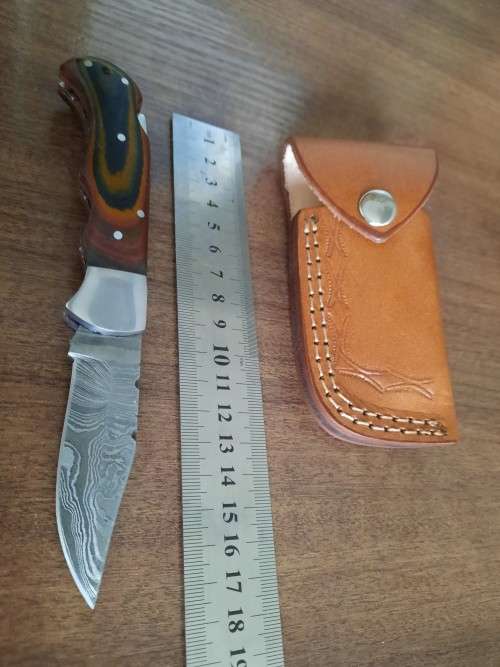 Handmade Damascus steel folding knife with MICARTA handle scales.
