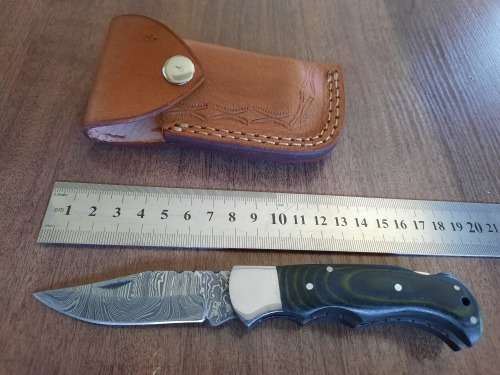 Handmade Damascus steel folding knife with MICARTA handle scales.
