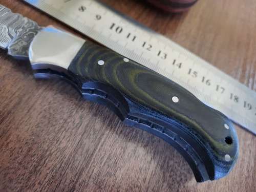 Handmade Damascus steel folding knife with MICARTA handle scales.