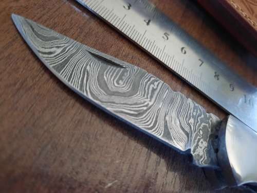 Handmade Damascus steel folding knife with MICARTA handle scales.
