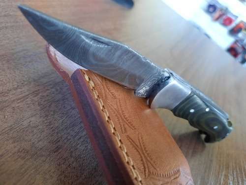 Handmade Damascus steel folding knife with MICARTA handle scales.