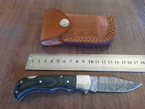 Handmade Damascus steel folding knife with MICARTA handle scales.