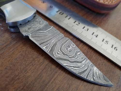 Handmade Damascus steel folding knife with MICARTA handle scales.
