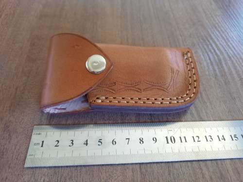 Handmade Damascus steel folding knife with MICARTA handle scales.