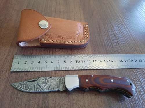 Handmade Damascus steel folding knife with MICARTA handle scales.