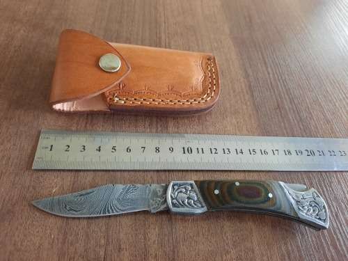 Handmade Damascus steel folding knife with MICARTA handle scales.