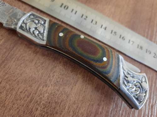 Handmade Damascus steel folding knife with MICARTA handle scales.