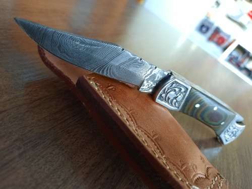 Handmade Damascus steel folding knife with MICARTA handle scales.
