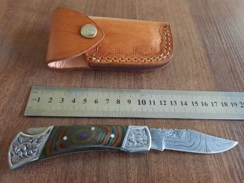 Handmade Damascus steel folding knife with MICARTA handle scales.