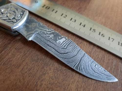 Handmade Damascus steel folding knife with MICARTA handle scales.