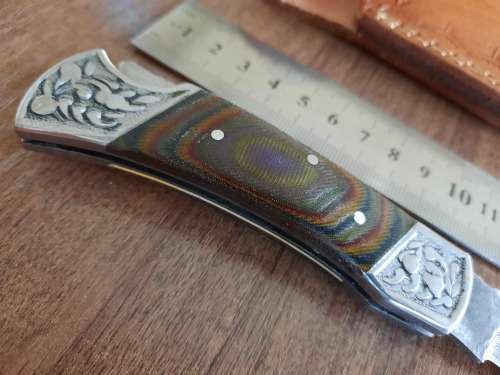 Handmade Damascus steel folding knife with MICARTA handle scales.