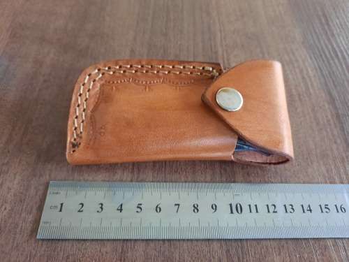Handmade Damascus steel folding knife with MICARTA handle scales.