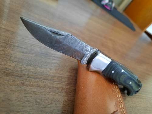 Handmade Damascus steel folding knife with MICARTA handle scales.