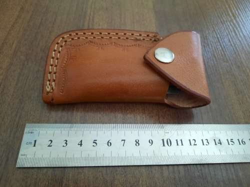 Handmade Damascus steel folding knife with MICARTA handle scales.