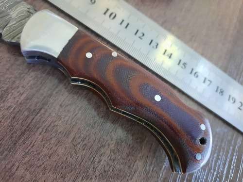 Handmade Damascus steel folding knife with MICARTA handle scales.