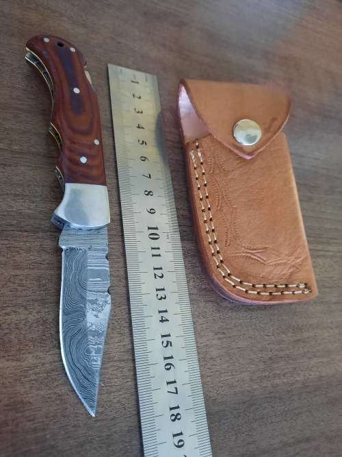 Handmade Damascus steel folding knife with MICARTA handle scales.