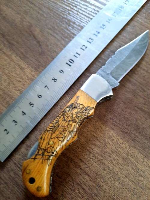 Handmade Damascus steel folding knife with wooden handle scales. OWL picture engraved. NEW STOCK !
