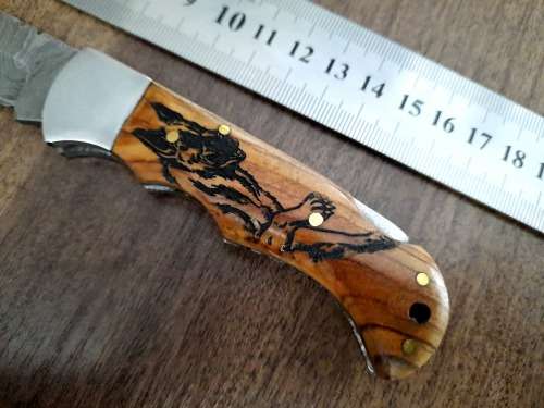 Handmade Damascus steel folding knife with wooden handle scales. Dog picture engraved. NEW STOCK !