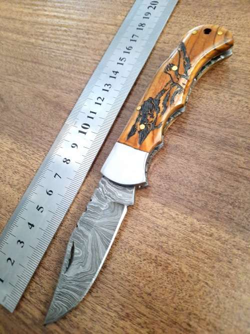 Handmade Damascus steel folding knife with wooden handle scales. Dog picture engraved. NEW STOCK !