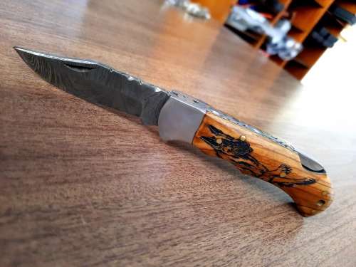 Handmade Damascus steel folding knife with wooden handle scales. Dog picture engraved. NEW STOCK !