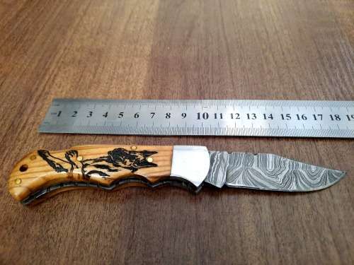 Handmade Damascus steel folding knife with wooden handle scales. Dog picture engraved. NEW STOCK !